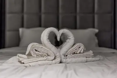 two towels are made to look like swans on a bed at Bounce Belgrade Apartment in Vračar (historical)