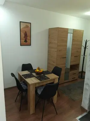 a dining room with a wooden table and chairs at Vidikovac in Belgrade