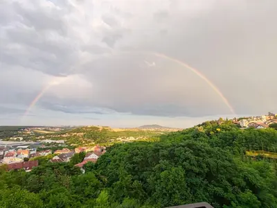 a rainbow in the sky over a city at Vidikovac in Belgrade