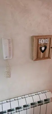 a home phone on the wall of a bathroom at Lux apartmann in Karaburma