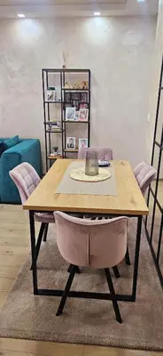 a wooden table with two chairs in a living room at Lux apartmann in Karaburma