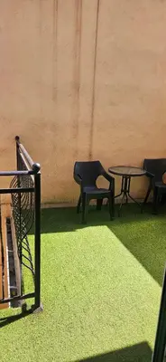 two chairs and a table and a table and chairs at Lux apartmann in Karaburma