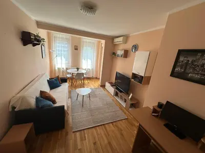a living room with a couch and a table at Angela apartment with 2 balconies in Belgrade