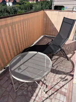 a table and a chair on a patio at Villa Ana - Charming Appartments in Belgrade