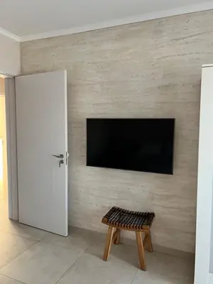 a living room with a tv on a wall at Villa Ana - Charming Appartments in Belgrade