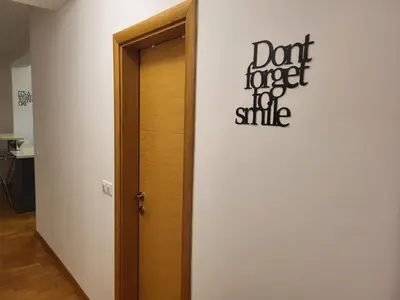 a door with a sign that reads dont forget the smile at BNB Apartments LUX in Belgrade