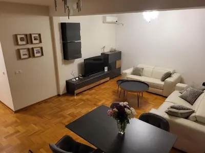 a living room with a table and a couch at BNB Apartments LUX in Belgrade