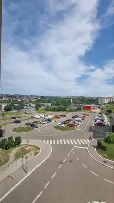 an empty parking lot with cars parked in a parking lot at Vels Suite in Voždovac