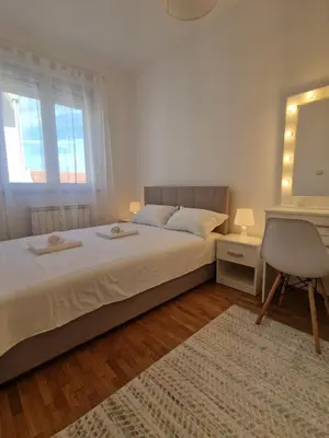 a bedroom with a bed with a desk and a chair at EMILY LUX Apartment Belgrade, Center in Belgrade