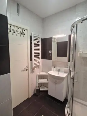 a white bathroom with a sink and a shower at EMILY LUX Apartment Belgrade, Center in Belgrade