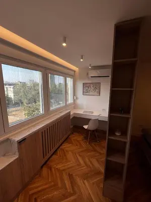 an empty room with a desk and a window at Berenji Lux Apartment in Fontana