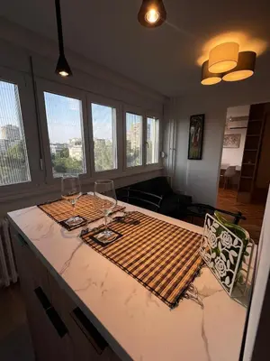 a kitchen with two wine glasses and a counter top at Berenji Lux Apartment in Fontana