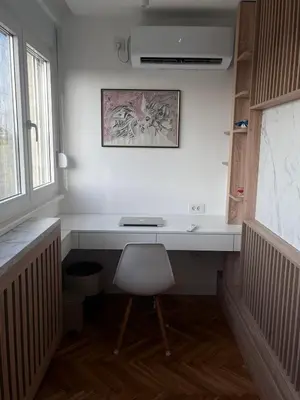 a white desk with a chair in a room at Berenji Lux Apartment in Fontana