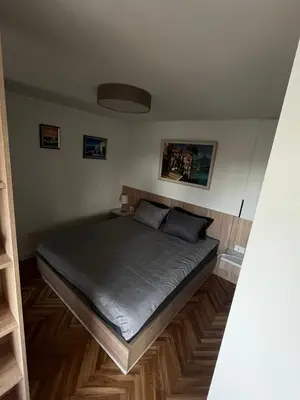 a bedroom with a large bed in a room at Berenji Lux Apartment in Fontana