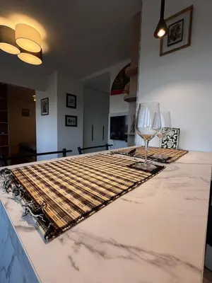 a table with two wine glasses on top of it at Berenji Lux Apartment in Fontana