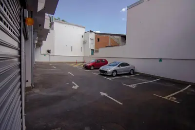 two cars parked in a parking lot in a building at Perla, family apartment with parking in Belgrade