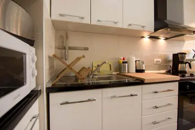 a kitchen with a sink and a microwave at Perla, family apartment with parking in Belgrade