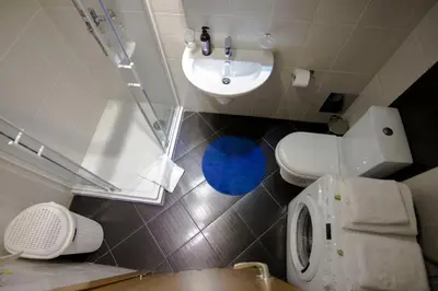 a small bathroom with a toilet and a sink at Perla, family apartment with parking in Belgrade