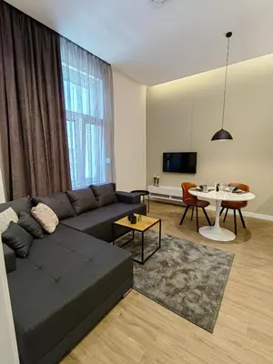 a living room with a couch and a table at Rajiceva for 4 one bdr one living room Knez Mihailova in Belgrade