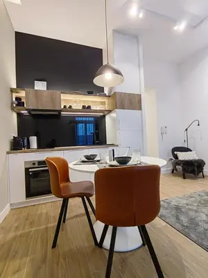 a kitchen with a table and chairs in a room at Rajiceva for 4 one bdr one living room Knez Mihailova in Belgrade