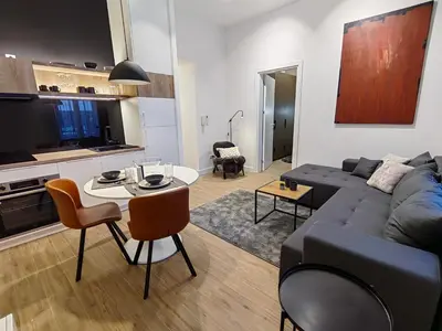 a living room with a couch and a table at Rajiceva for 4 one bdr one living room Knez Mihailova in Belgrade