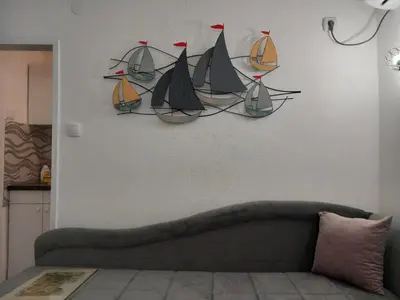 a wall with a bunch of model boats on it at Studio Djurdjica in Belgrade