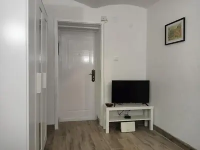 a living room with a television on a white table at Studio Djurdjica in Belgrade