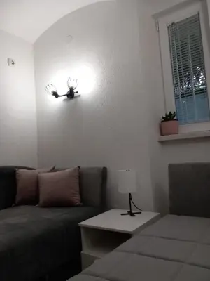 a living room with a couch and a light on the wall at Studio Djurdjica in Belgrade