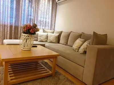 a living room with a couch and a coffee table at Shabby Chik, cozy apartment near St Sava Temple in Belgrade