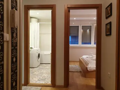a view of a bedroom with a bed and a bathroom at Shabby Chik, cozy apartment near St Sava Temple in Belgrade
