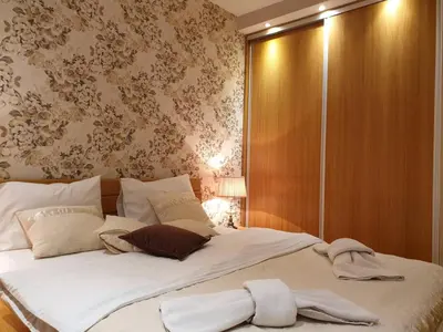 a bed with two towels on it in a bedroom at Shabby Chik, cozy apartment near St Sava Temple in Belgrade
