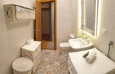 a white bathroom with a sink and a toilet at Shabby Chik, cozy apartment near St Sava Temple in Belgrade