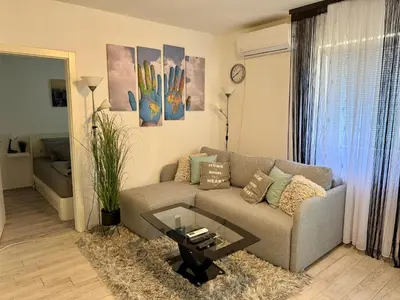 a living room with a couch and a table at Apartman Kutak in Belgrade