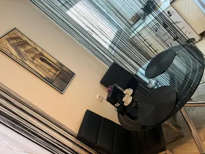 a dining room with a glass table and chairs at Apartman Kutak in Belgrade