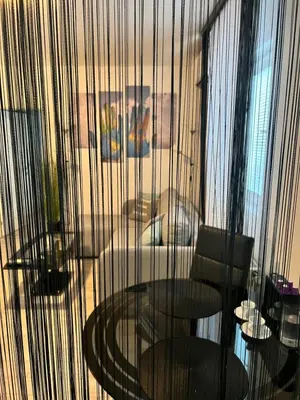 a room with a table and two chairs and a window at Apartman Kutak in Belgrade