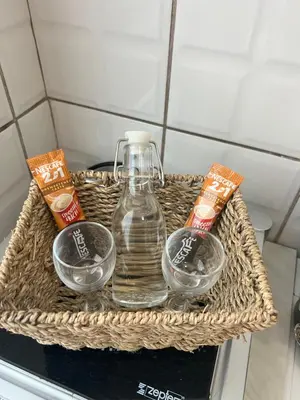 a basket with a bottle of water and two bowls at Apartman Kutak in Belgrade