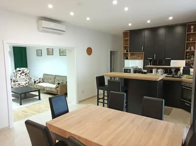 a kitchen and living room with a table and chairs at 150sqm 3BDR Family apartment in central Belgrade in Belgrade