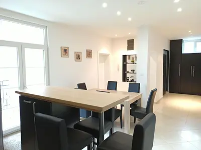 a dining room with a wooden table and chairs at 150sqm 3BDR Family apartment in central Belgrade in Belgrade
