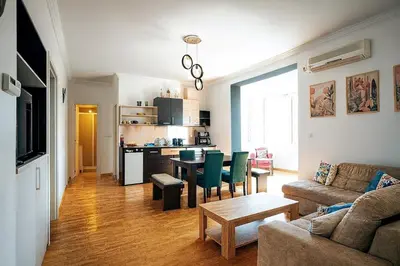 a living room with a couch and a table and a kitchen at Spacious 3BDR Central apartment near Terazije & BW in Belgrade
