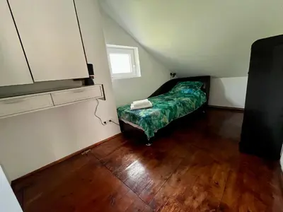 a small bedroom with a bed and a window at Urban Oasis in Belgrade