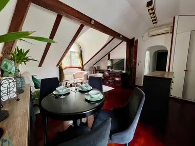 a living room with a table and chairs at Urban Oasis in Belgrade