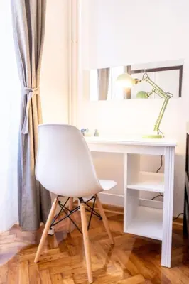 a white desk with a lamp and a white chair at Central and Comfy 2BDR apartment near Parliament in Belgrade