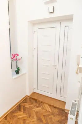 a room with a white door and a wooden floor at Central and Comfy 2BDR apartment near Parliament in Belgrade