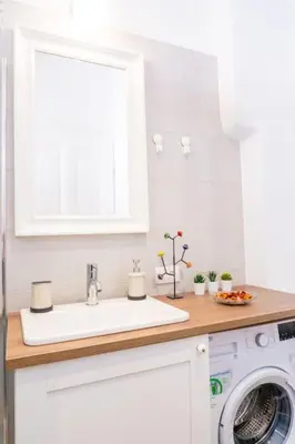a kitchen with a sink and a washing machine at Central and Comfy 2BDR apartment near Parliament in Belgrade
