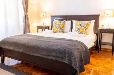 a bedroom with a large bed with pillows at Central and Comfy 2BDR apartment near Parliament in Belgrade