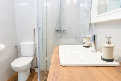 a bathroom with a toilet and a shower and a sink at Central and Comfy 2BDR apartment near Parliament in Belgrade