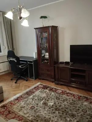a living room with a desk and a television at Luna in Vračar (historical)