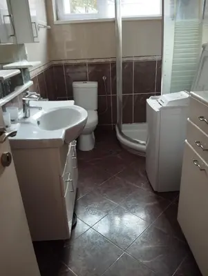 a bathroom with a sink and a toilet and a shower at Luna in Vračar (historical)
