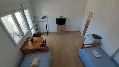 a living room with a blue couch and a table at Udobna Dvokrevetna Soba Sa Terasom #2 in Mladenovac