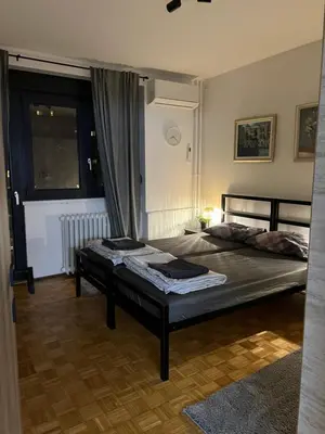 a bedroom with a bed and a window at Oasis Residences B in Belgrade